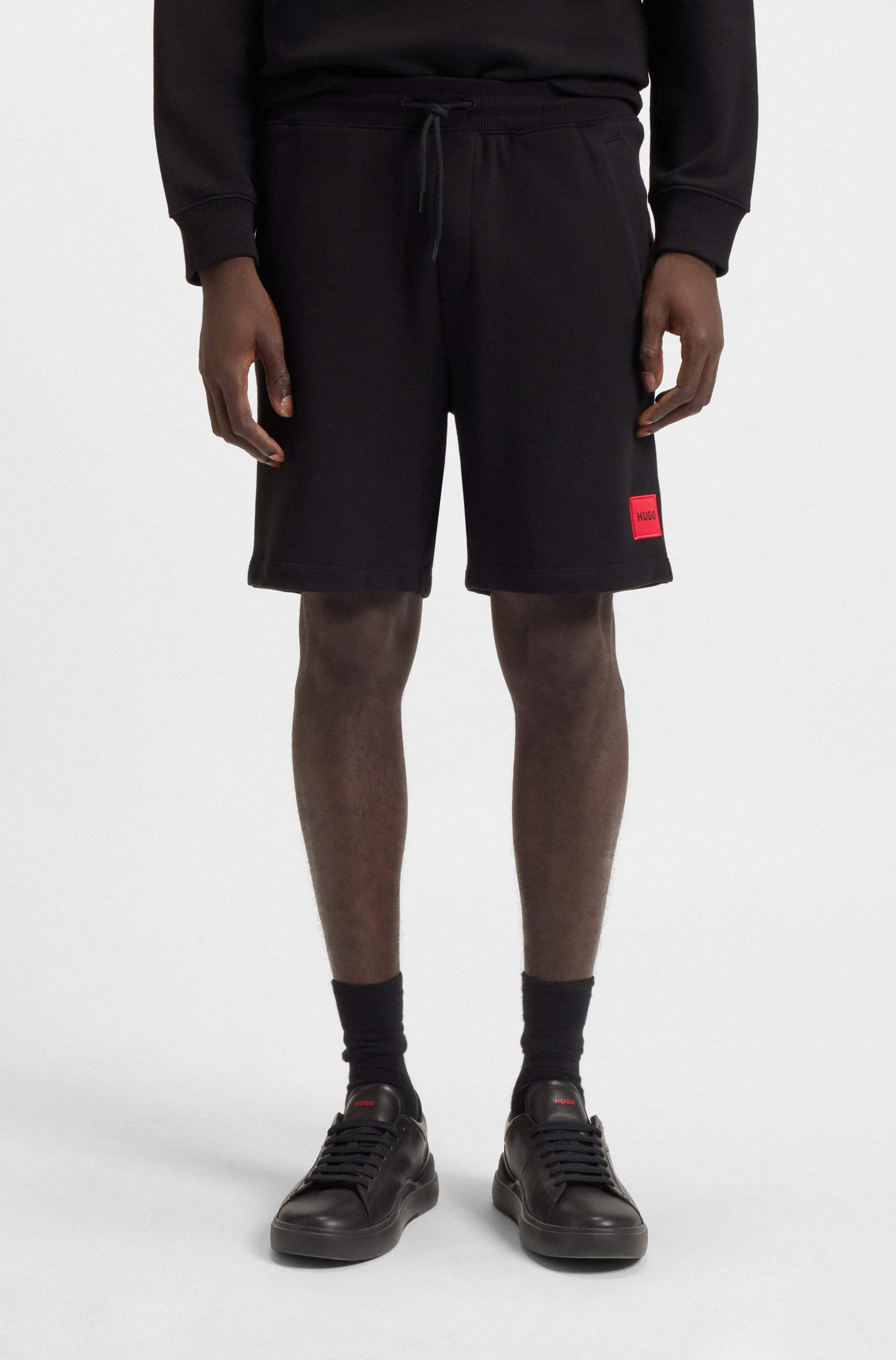 Cotton-terry shorts with red logo label