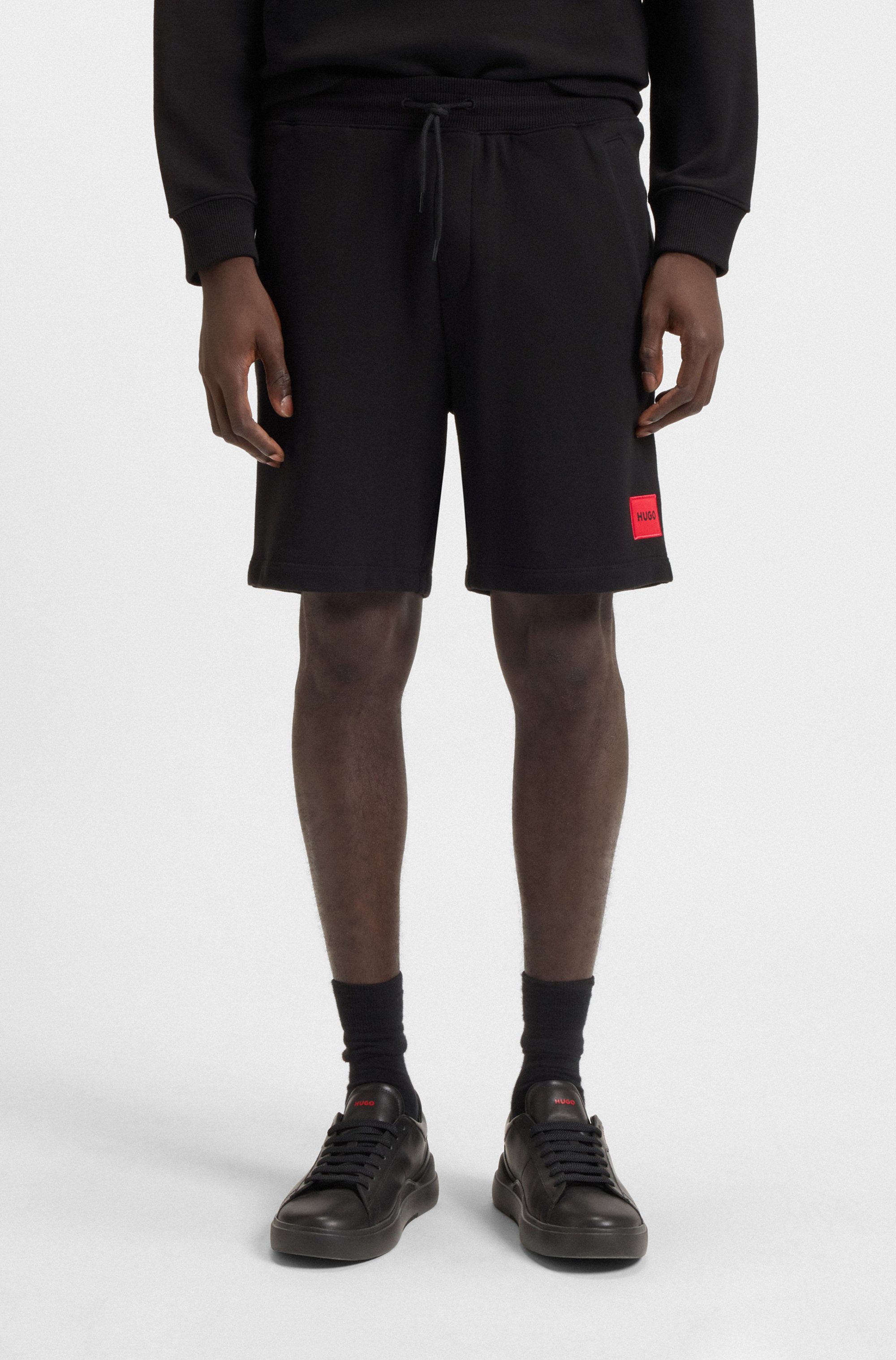 Cotton-terry shorts with red logo label