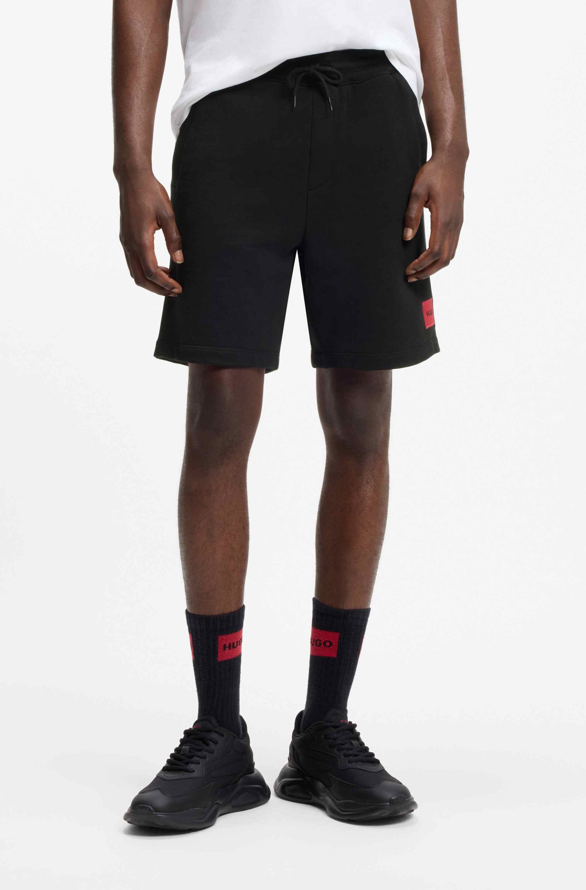 Cotton-terry shorts with red logo label