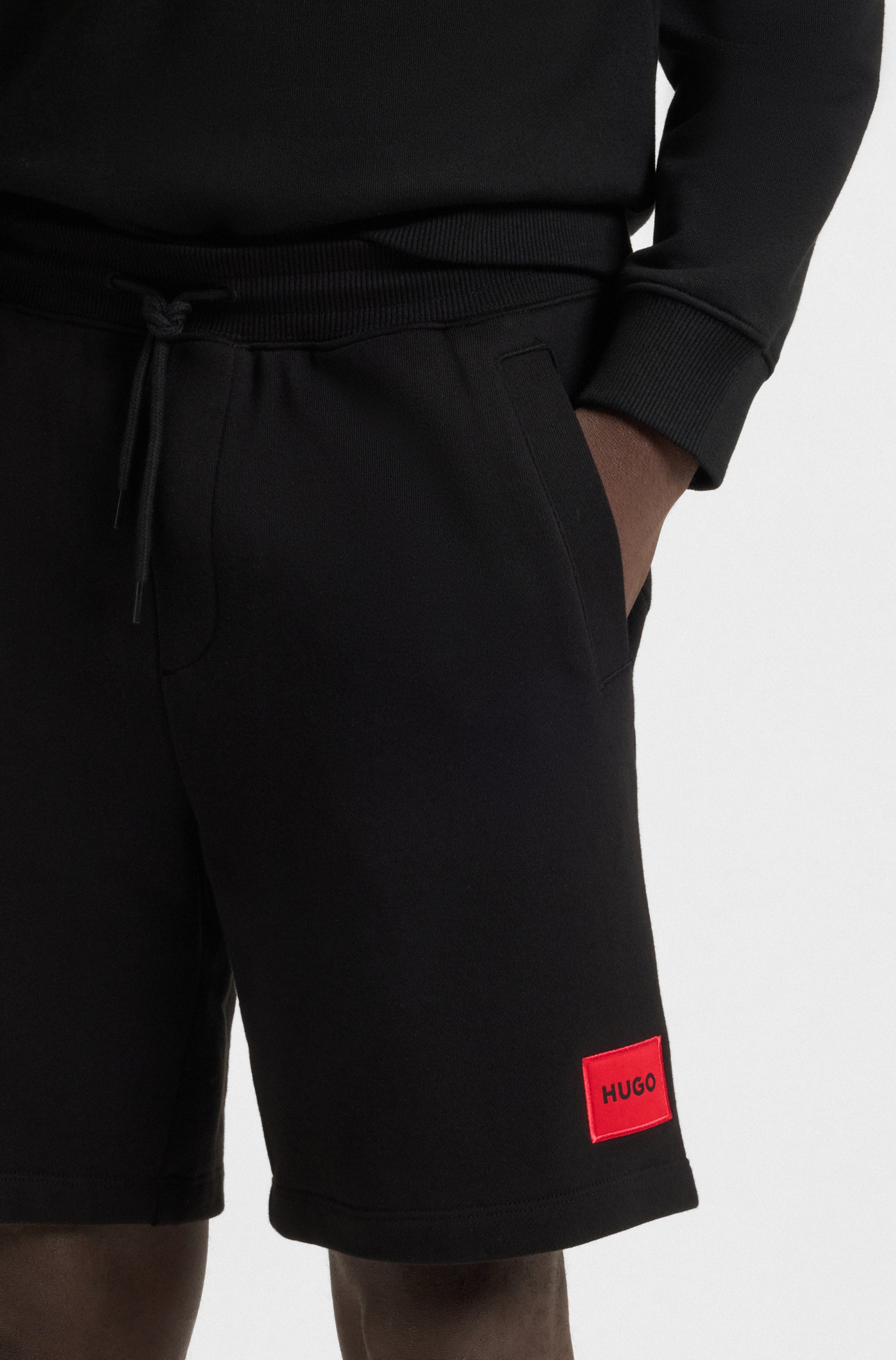 Cotton-terry shorts with red logo label