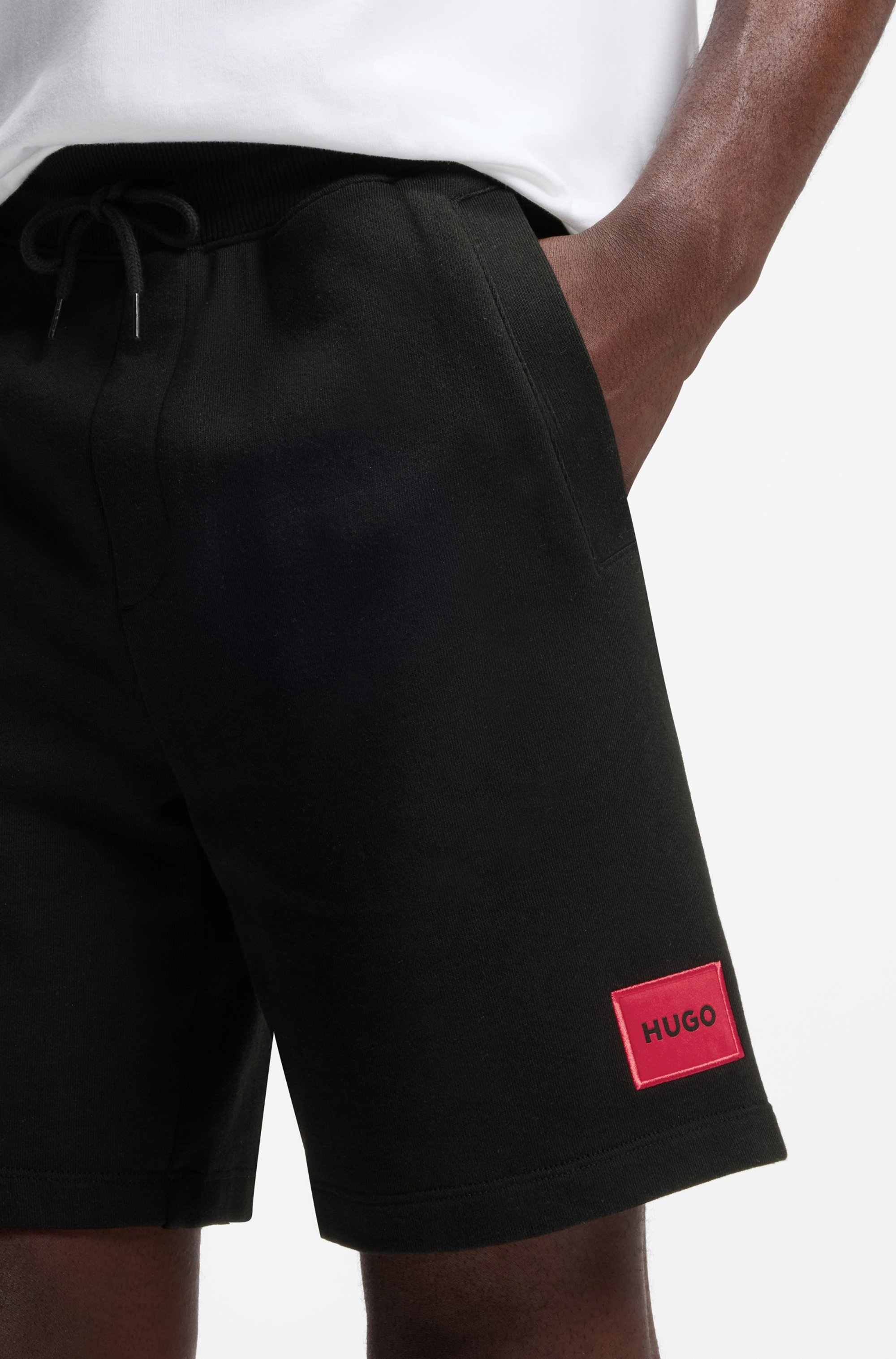 Cotton-terry shorts with red logo label