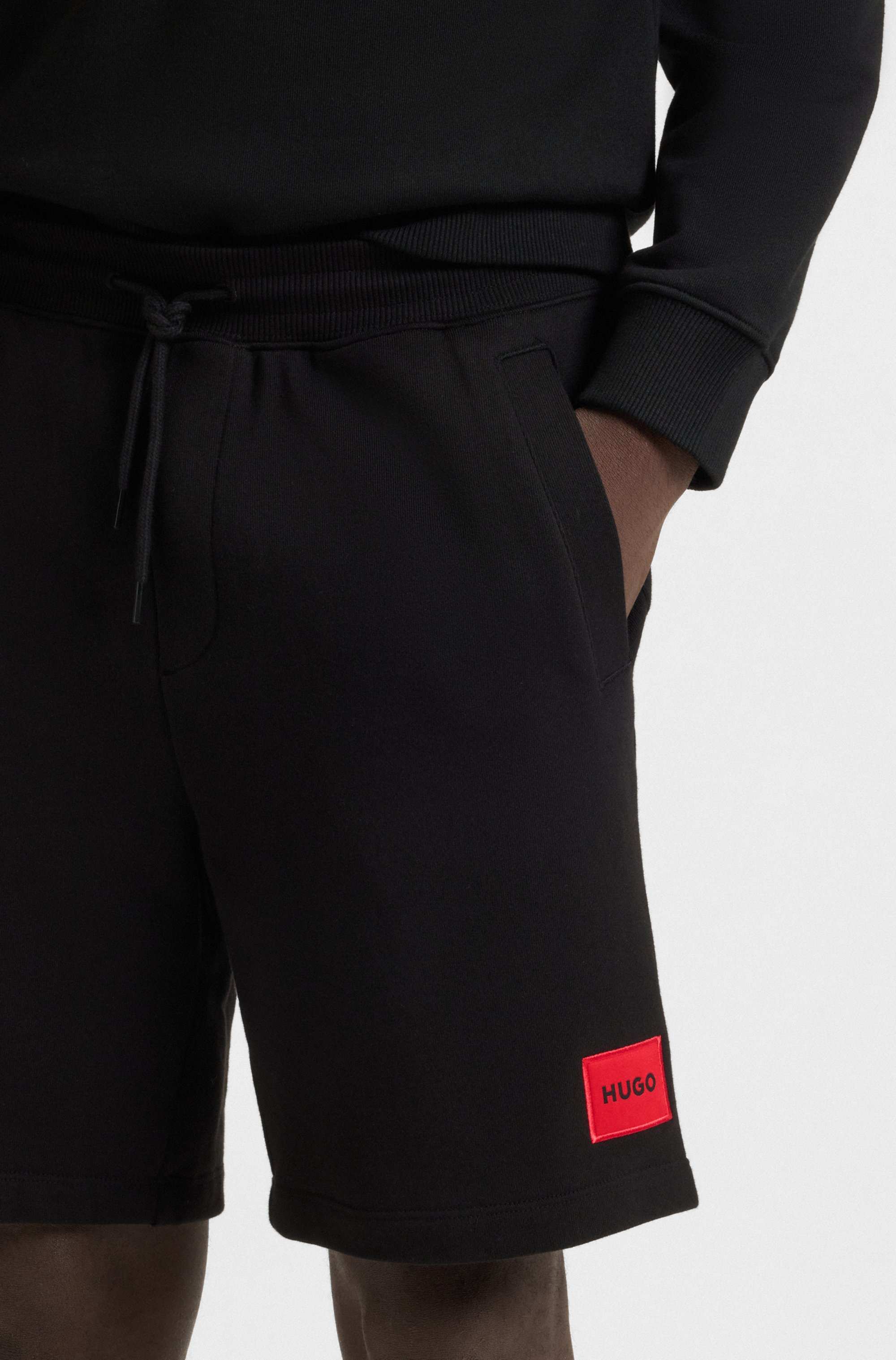 Cotton-terry shorts with red logo label