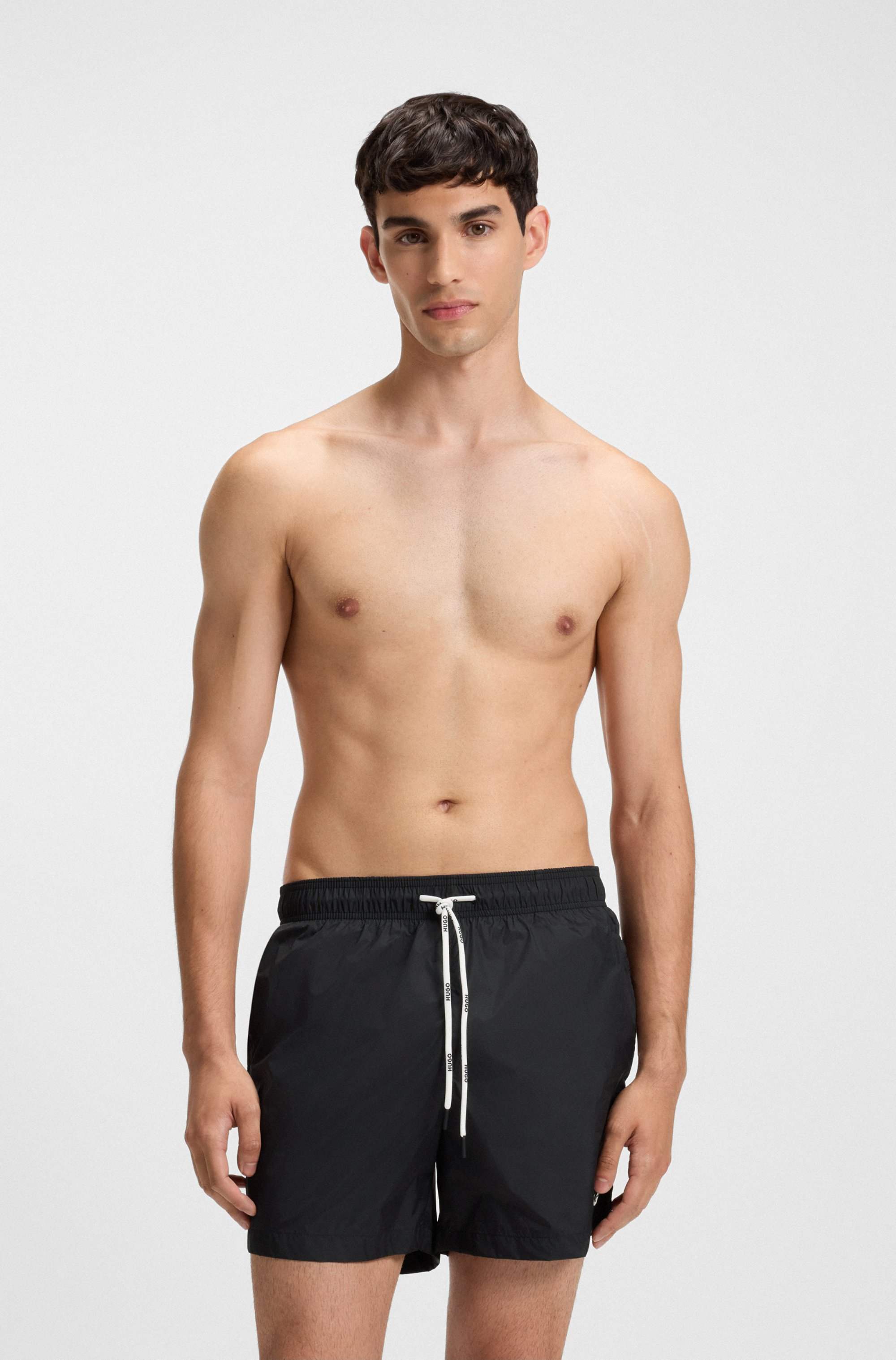 Fully lined swim shorts with contrast logo