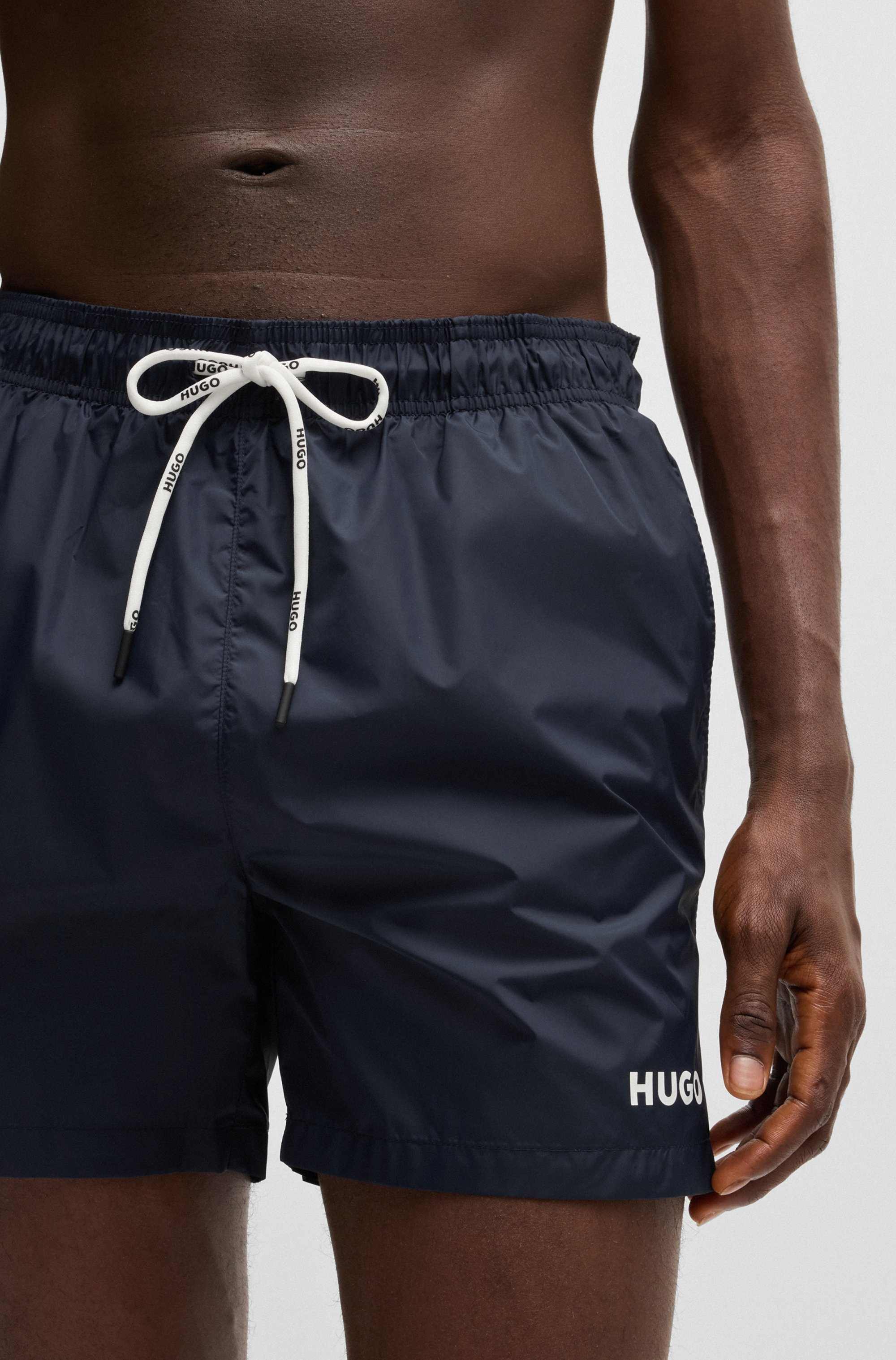 Fully lined swim shorts with contrast logo