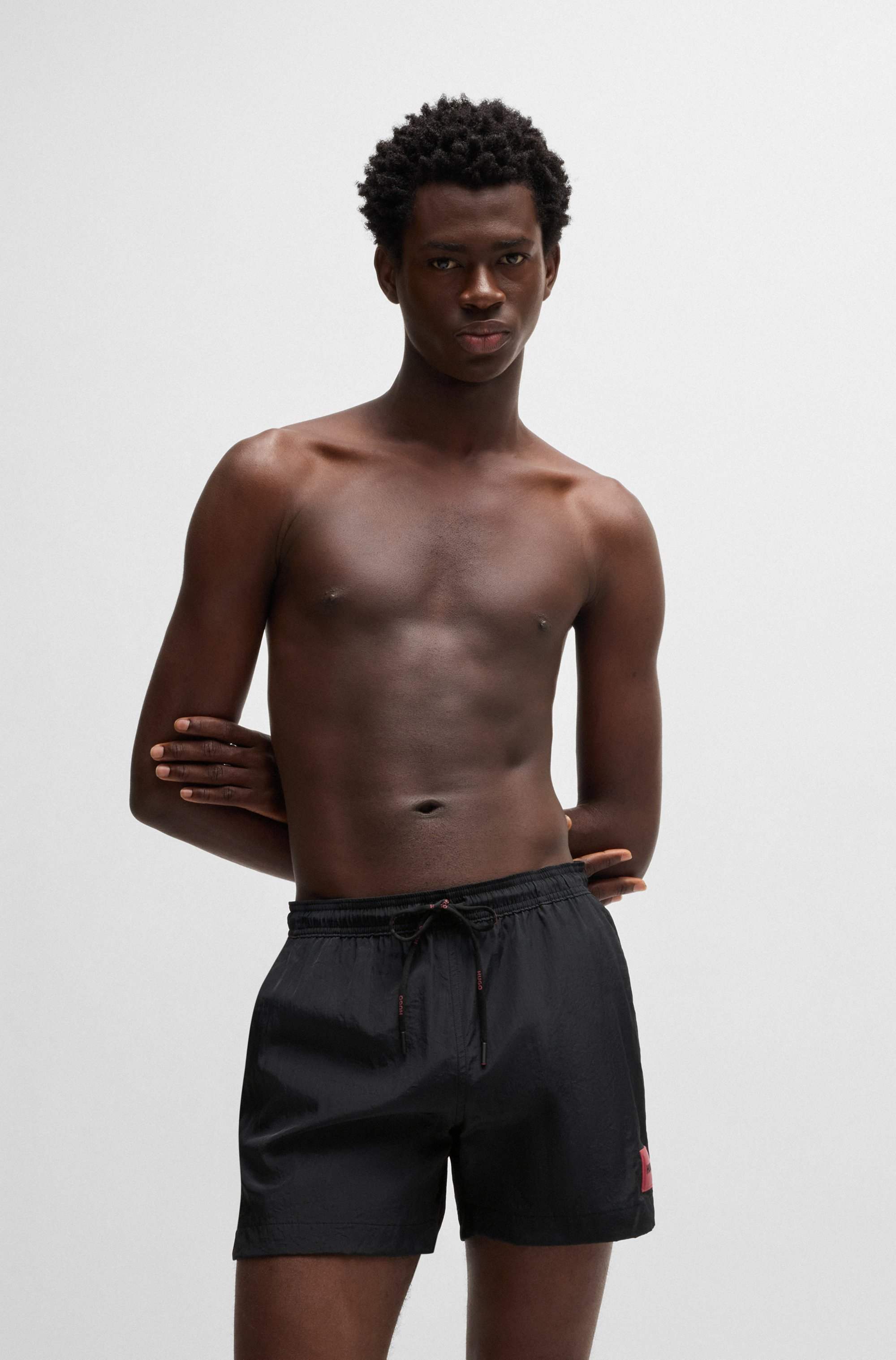 Fully lined swim shorts with red logo label