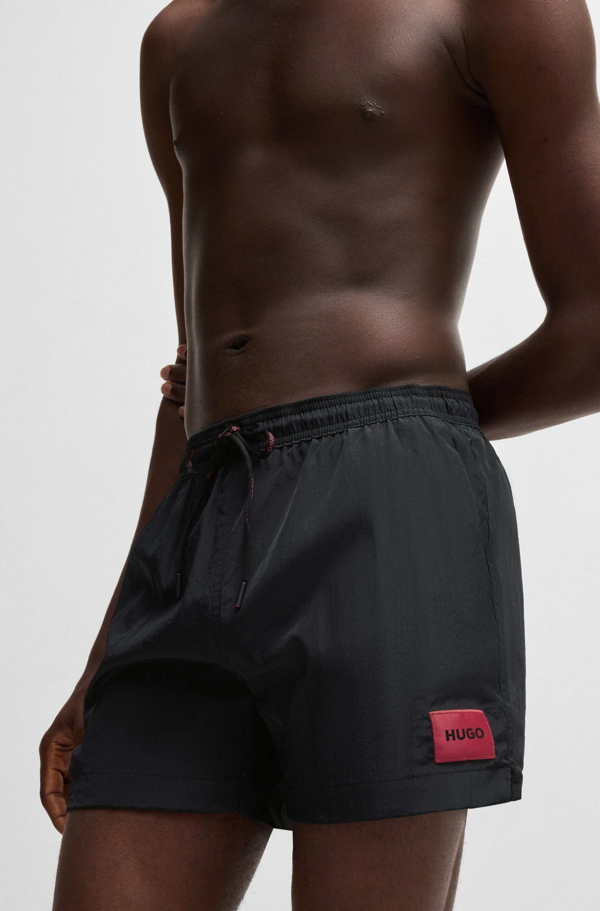 Fully lined swim shorts with red logo label