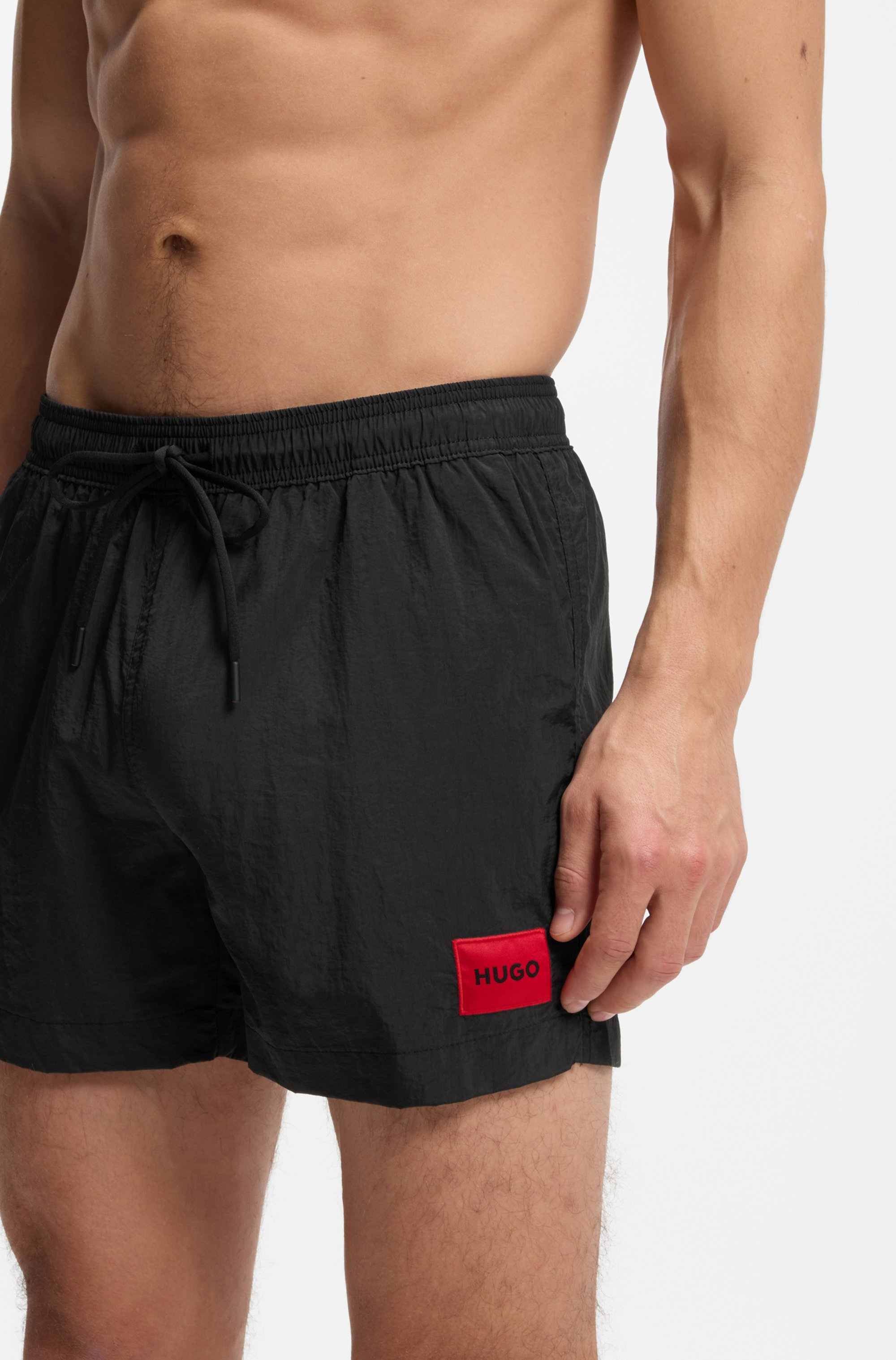 Quick-dry swim shorts with logo label