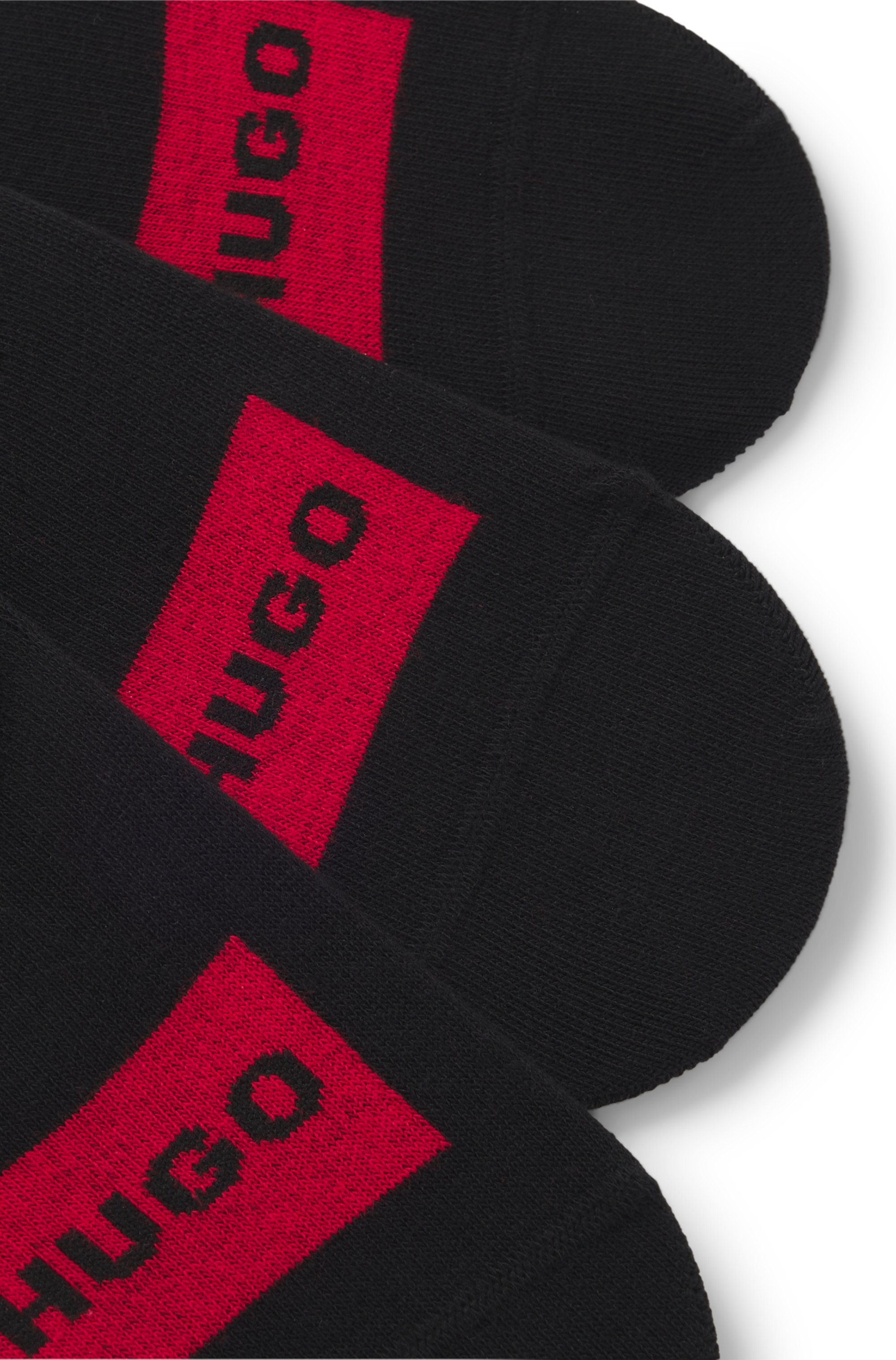 Three-pack of invisible socks with red logo labels