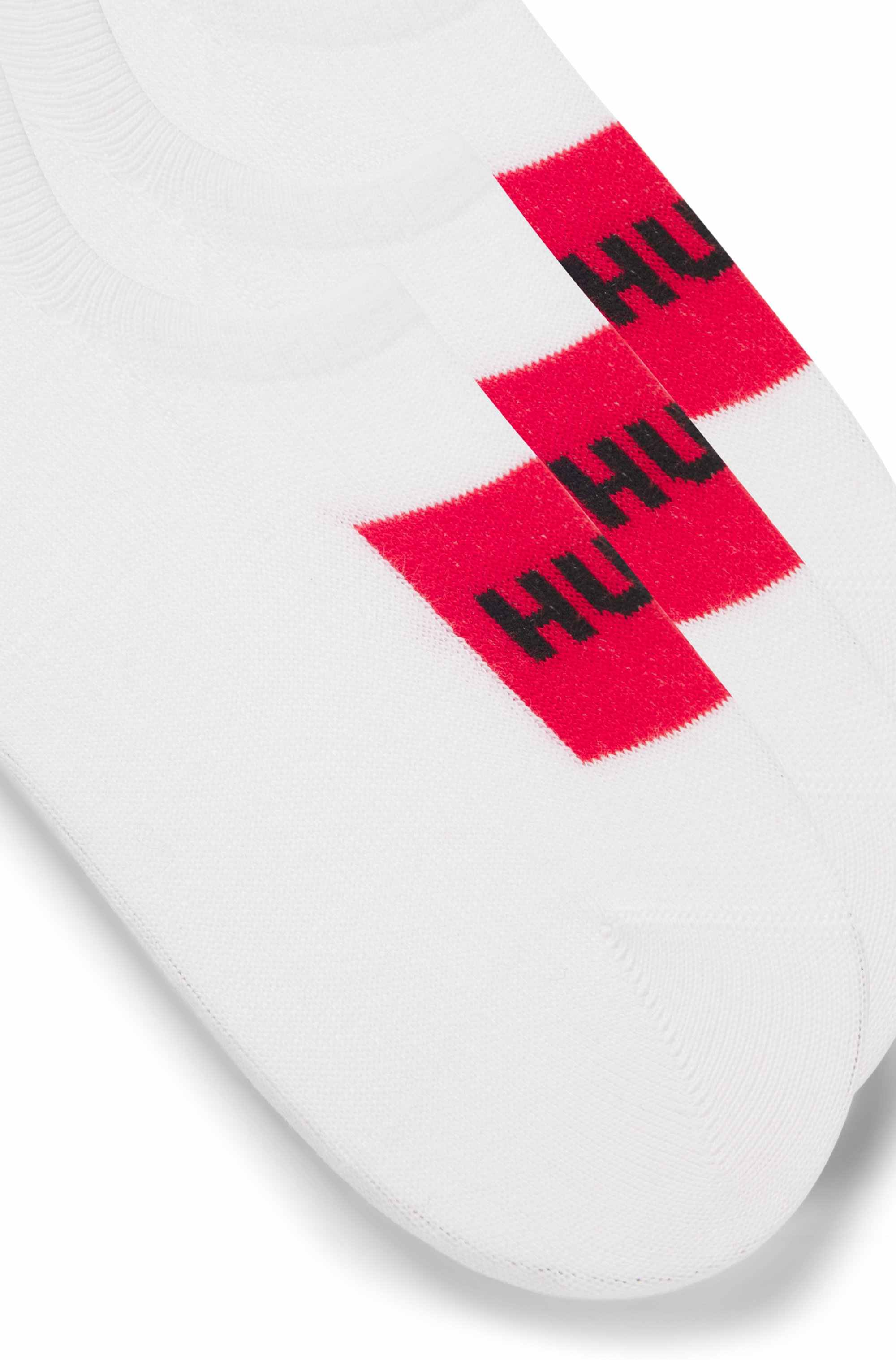 Three-pack of invisible socks with red logo labels