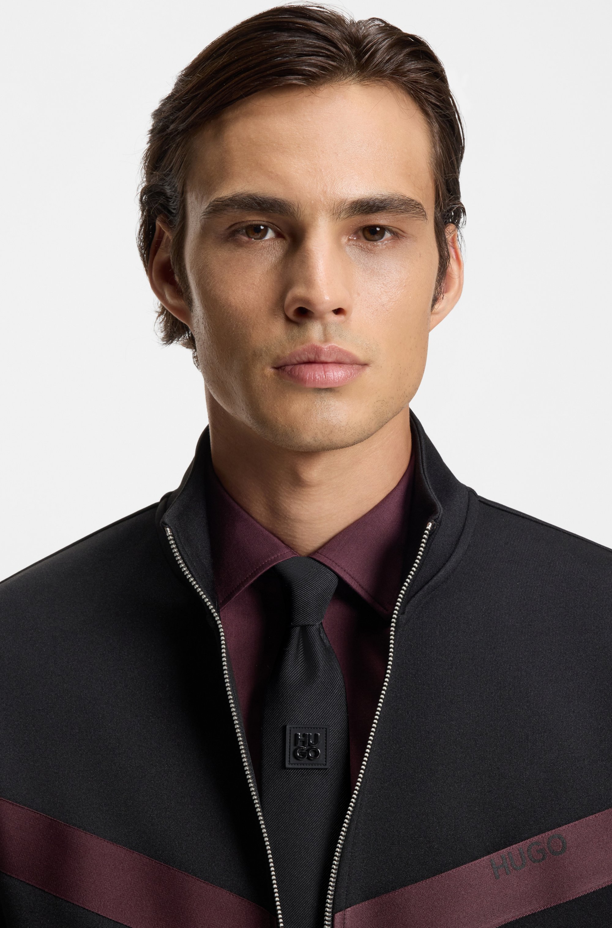 Jacquard-woven tie with metallic stacked-logo trim