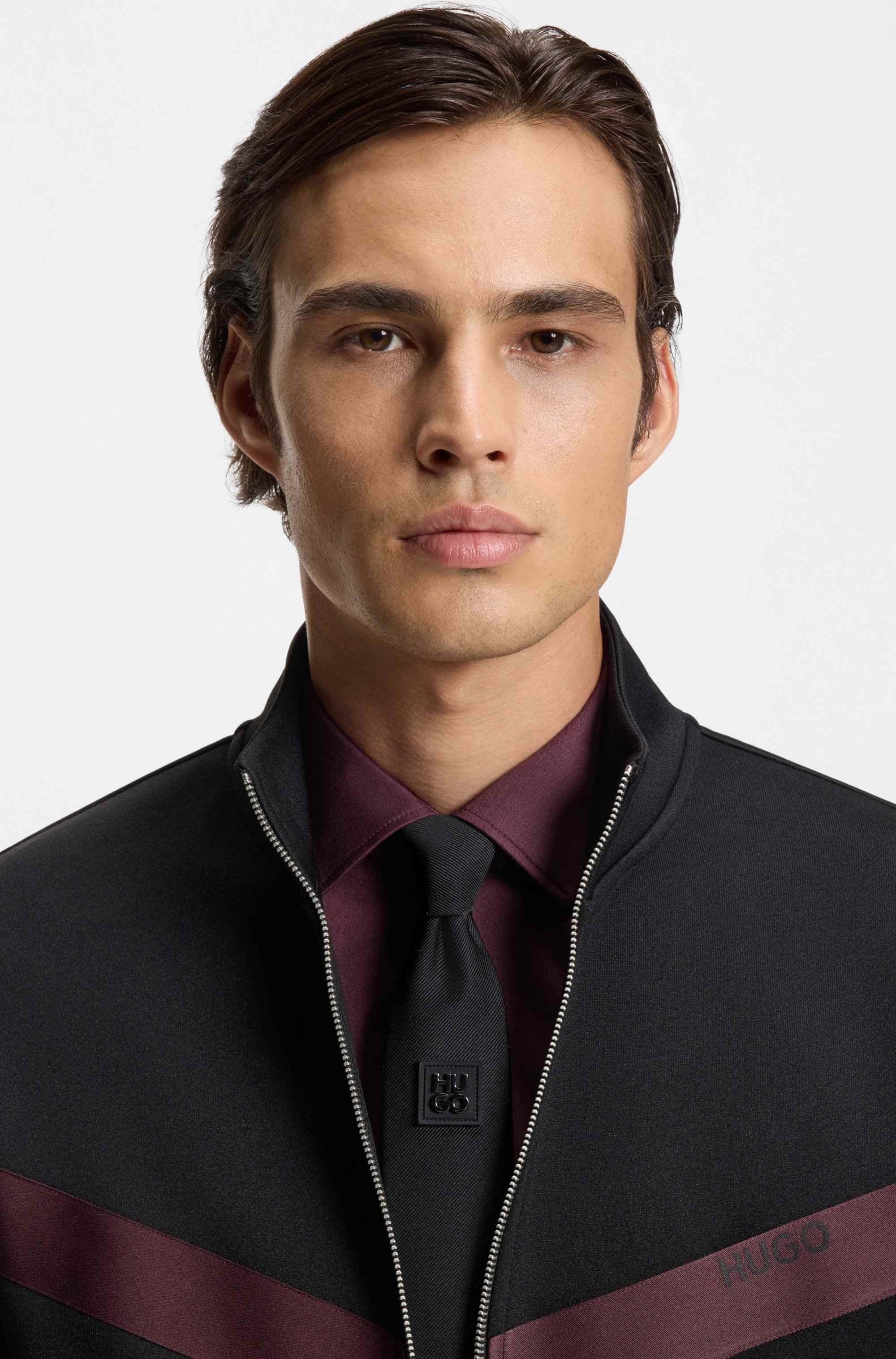 Jacquard-woven tie with metallic stacked-logo trim