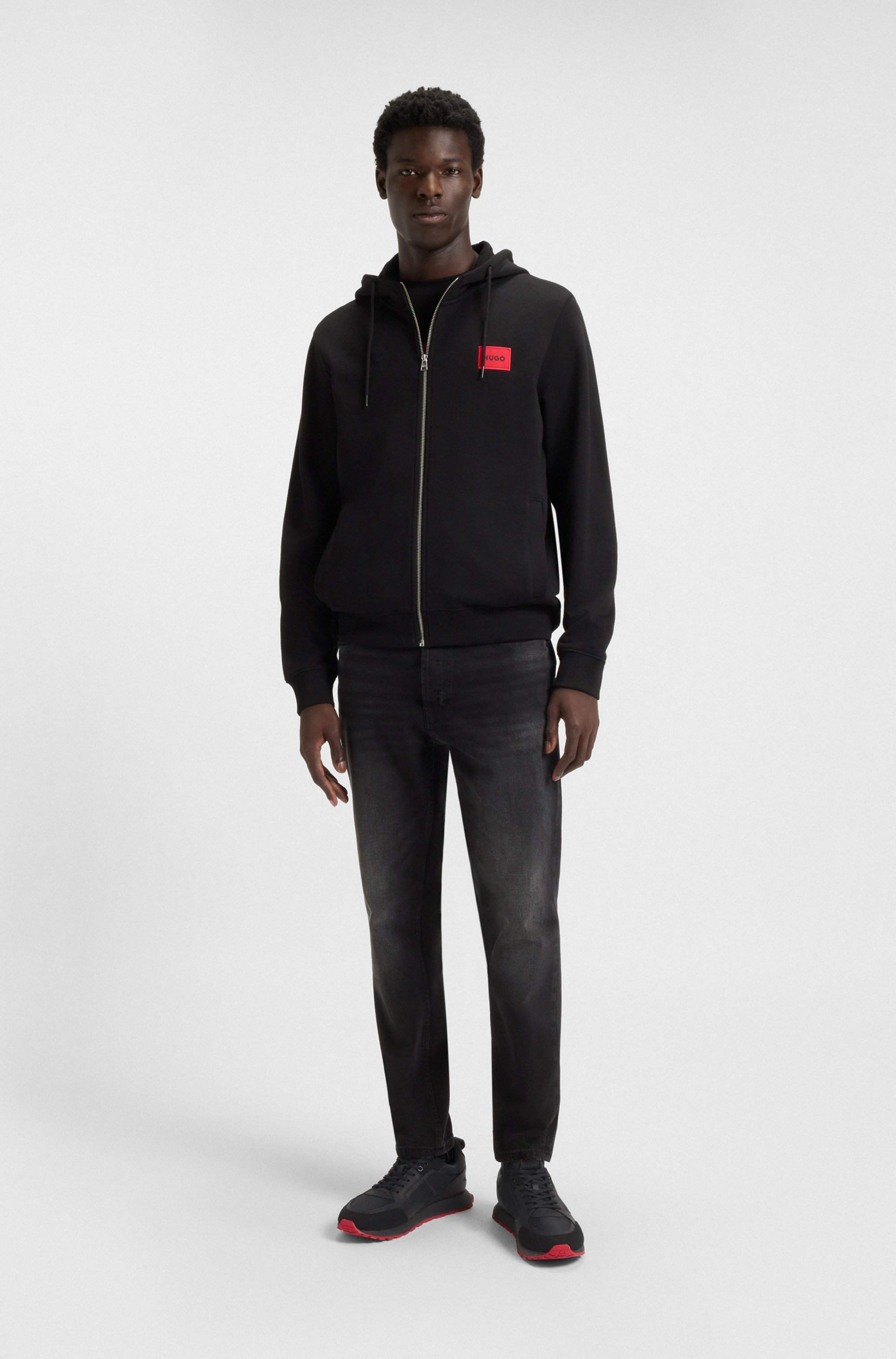 Mixed-material trainers with branded accents