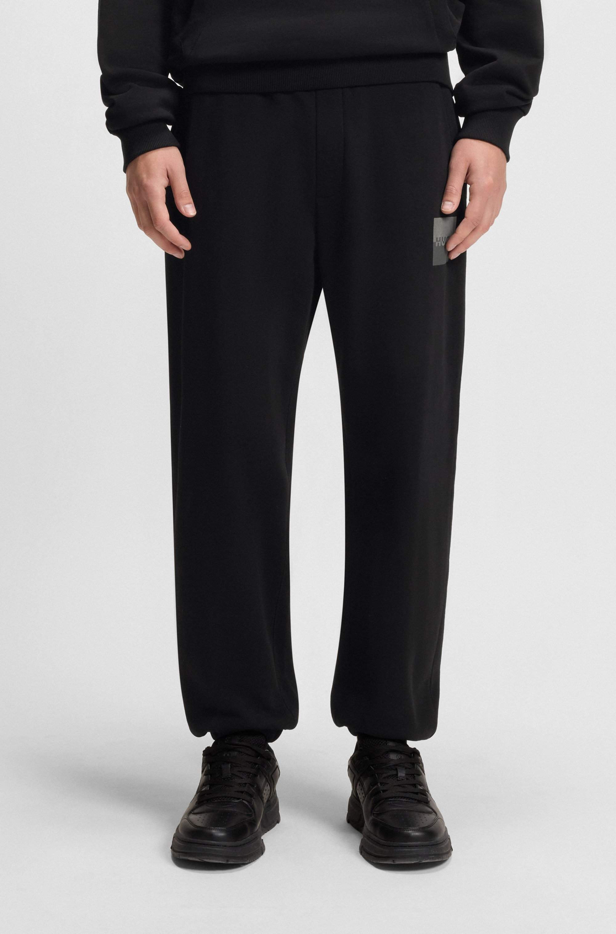 Cotton-terry tracksuit bottoms with split logo