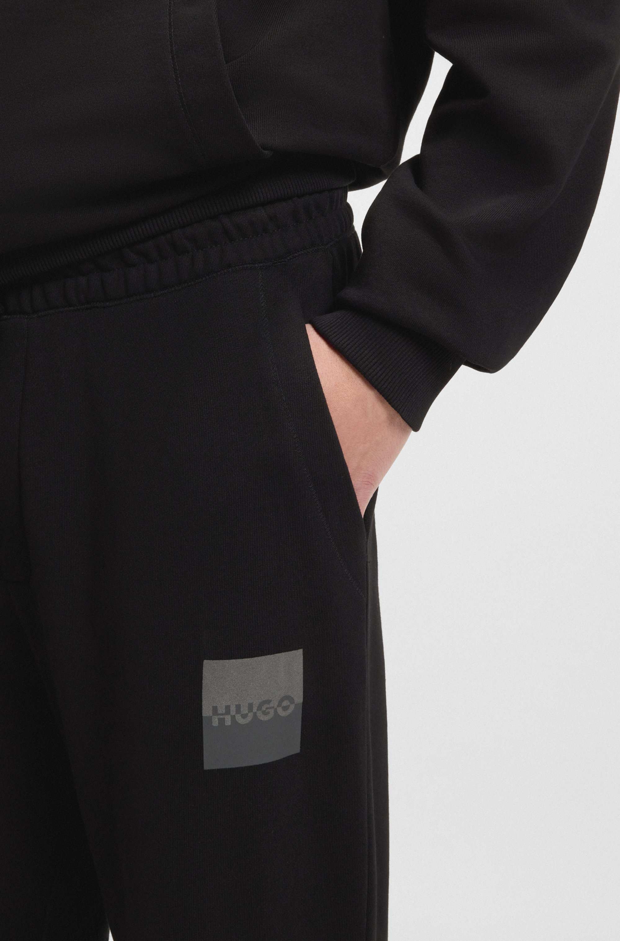 Cotton-terry tracksuit bottoms with split logo