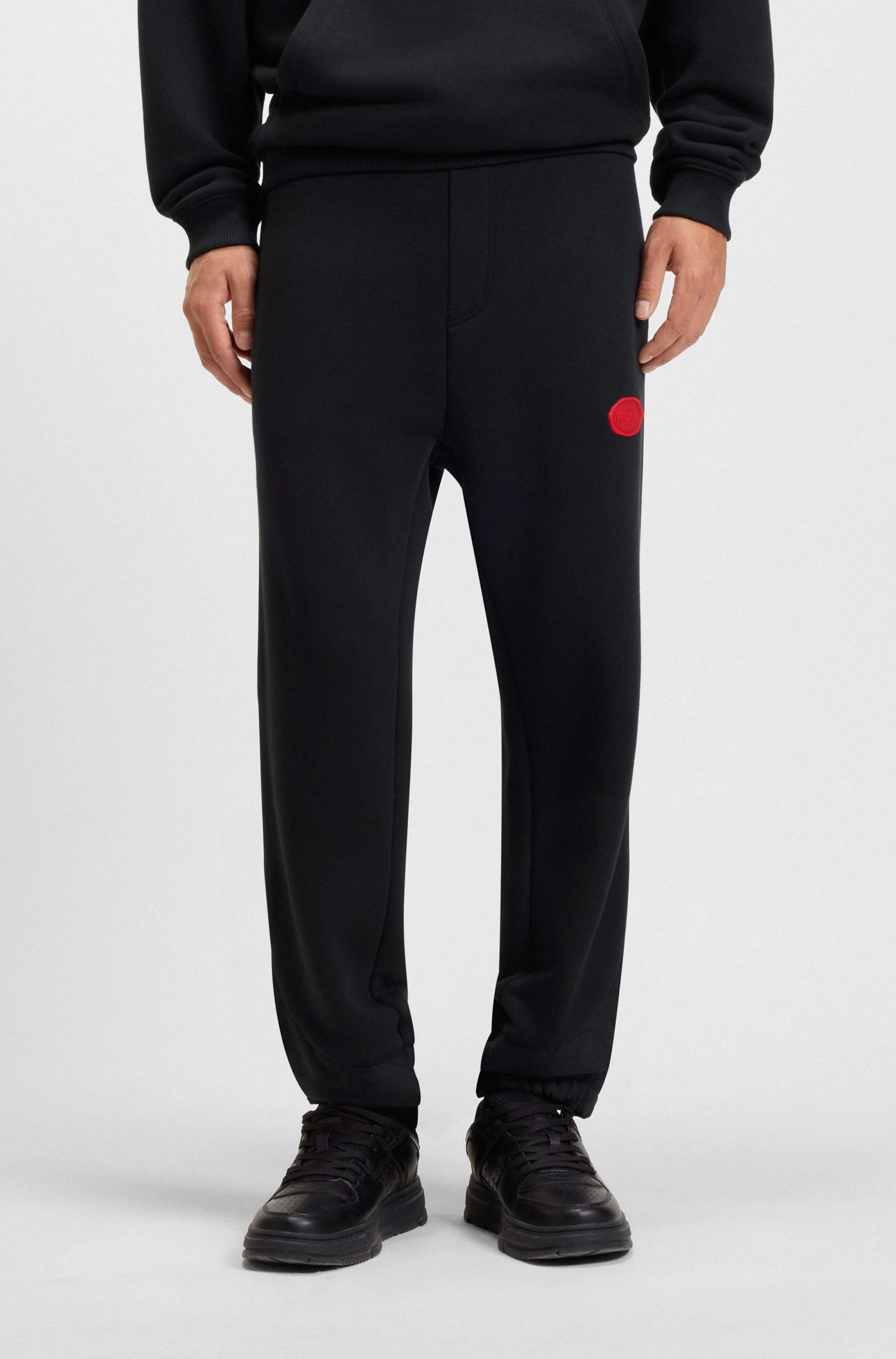 Cotton-blend tracksuit bottoms with waxed-stamp logo