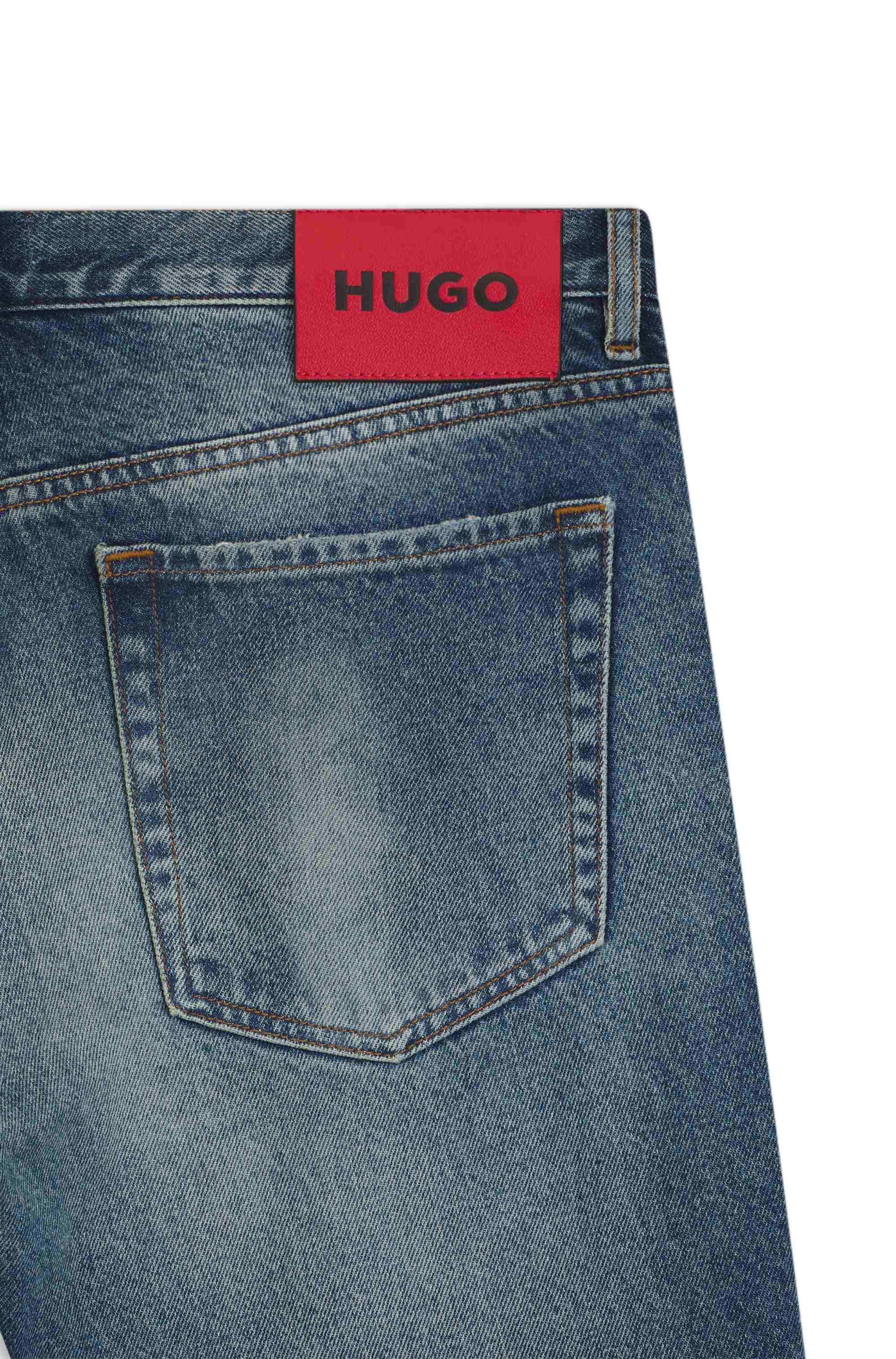 Tapered-fit jeans in distressed blue denim