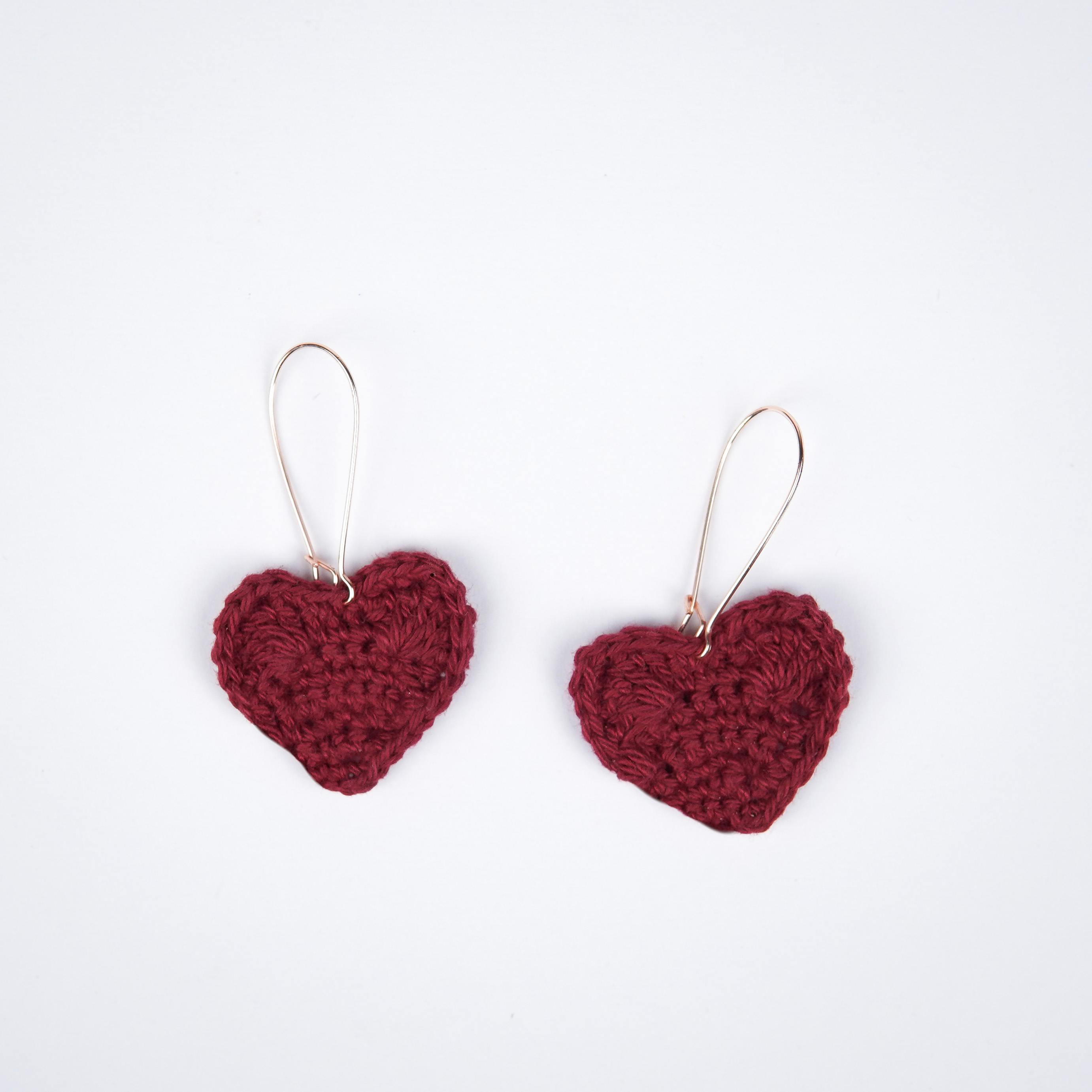  Close-up view of the deep, rich maroon shade of the crochet heart earrings