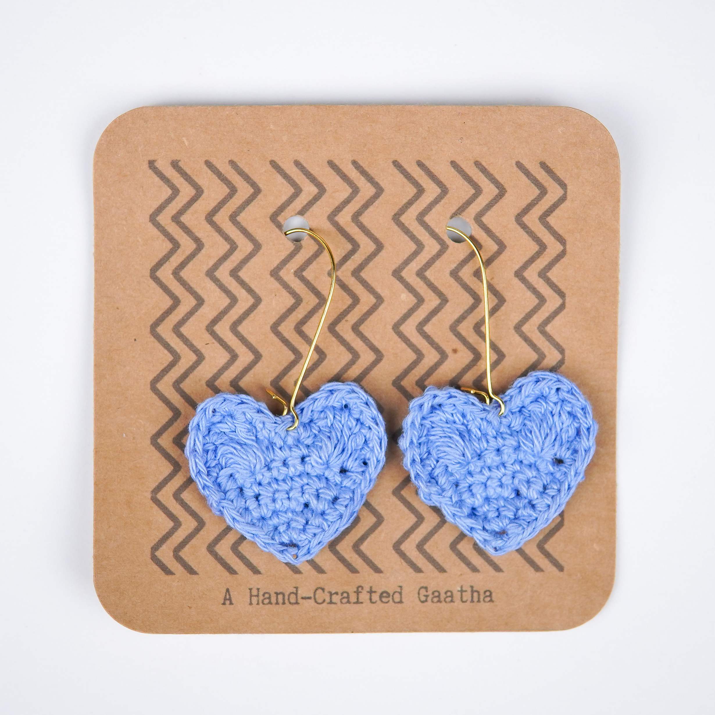 Close-up of the Asmaani blue shade and the intricate crochet details of the heart earrings
