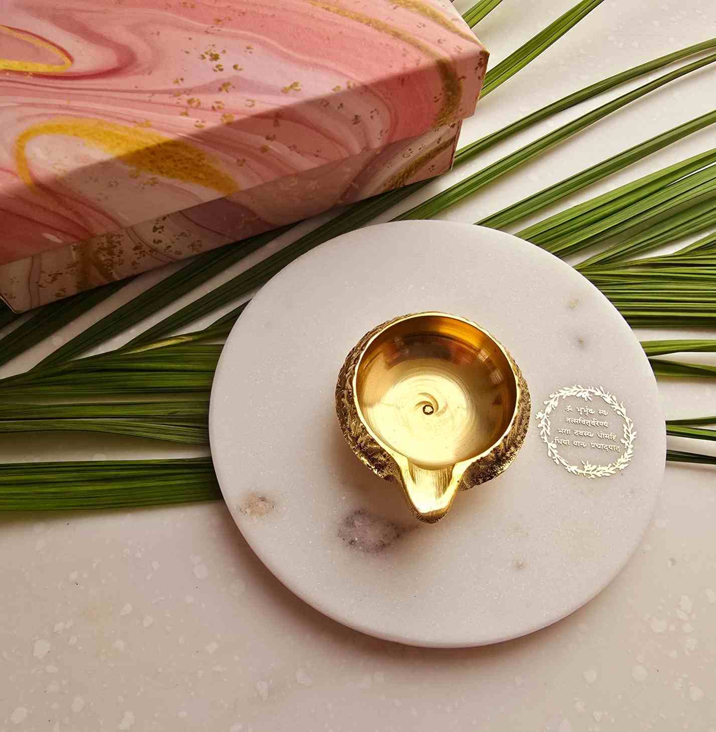 Brass diya in combination with white Indian Marble.
