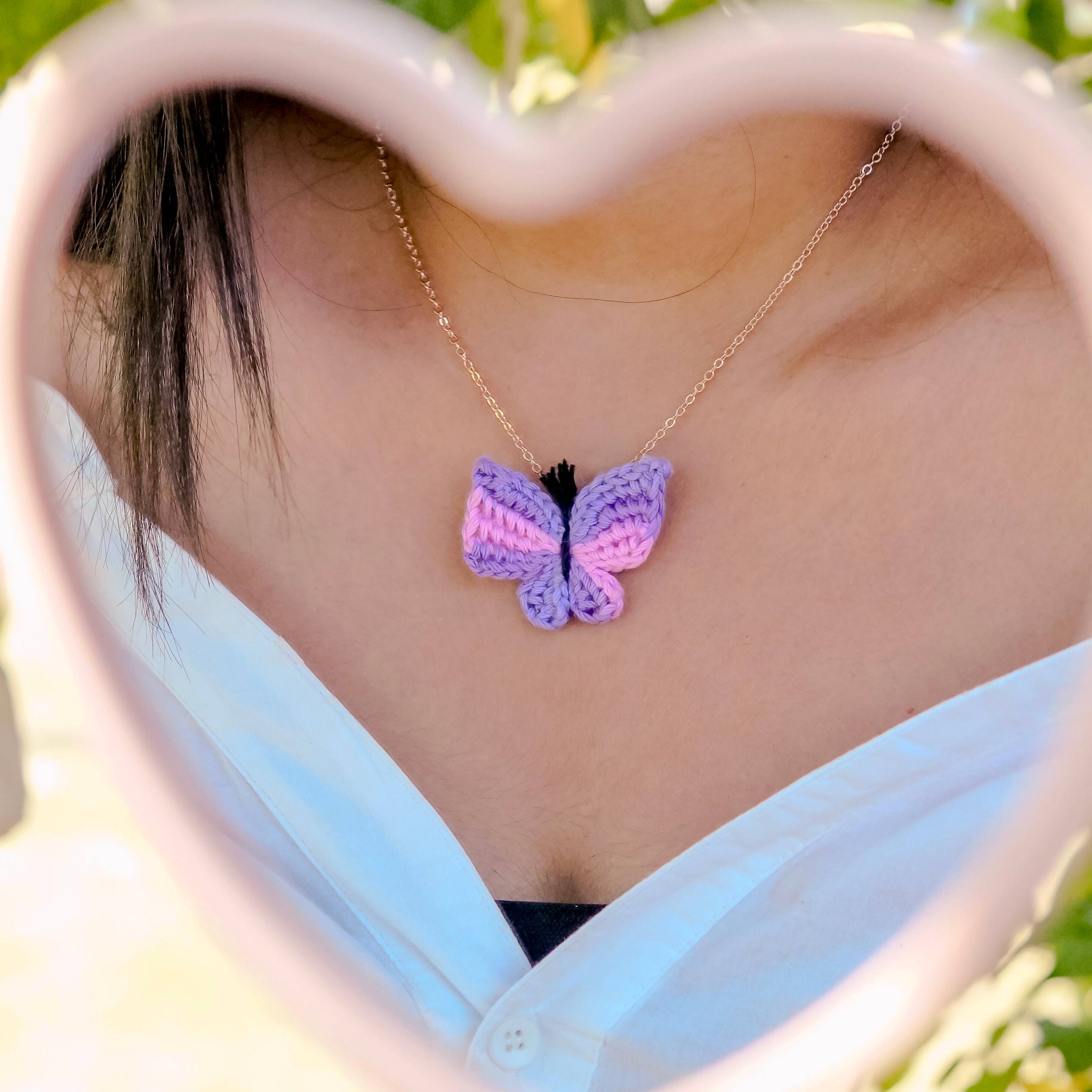 : Model wearing the pink & purple titli pendant by A Handcrafted Gaatha, adding a touch of spring to the outfit
