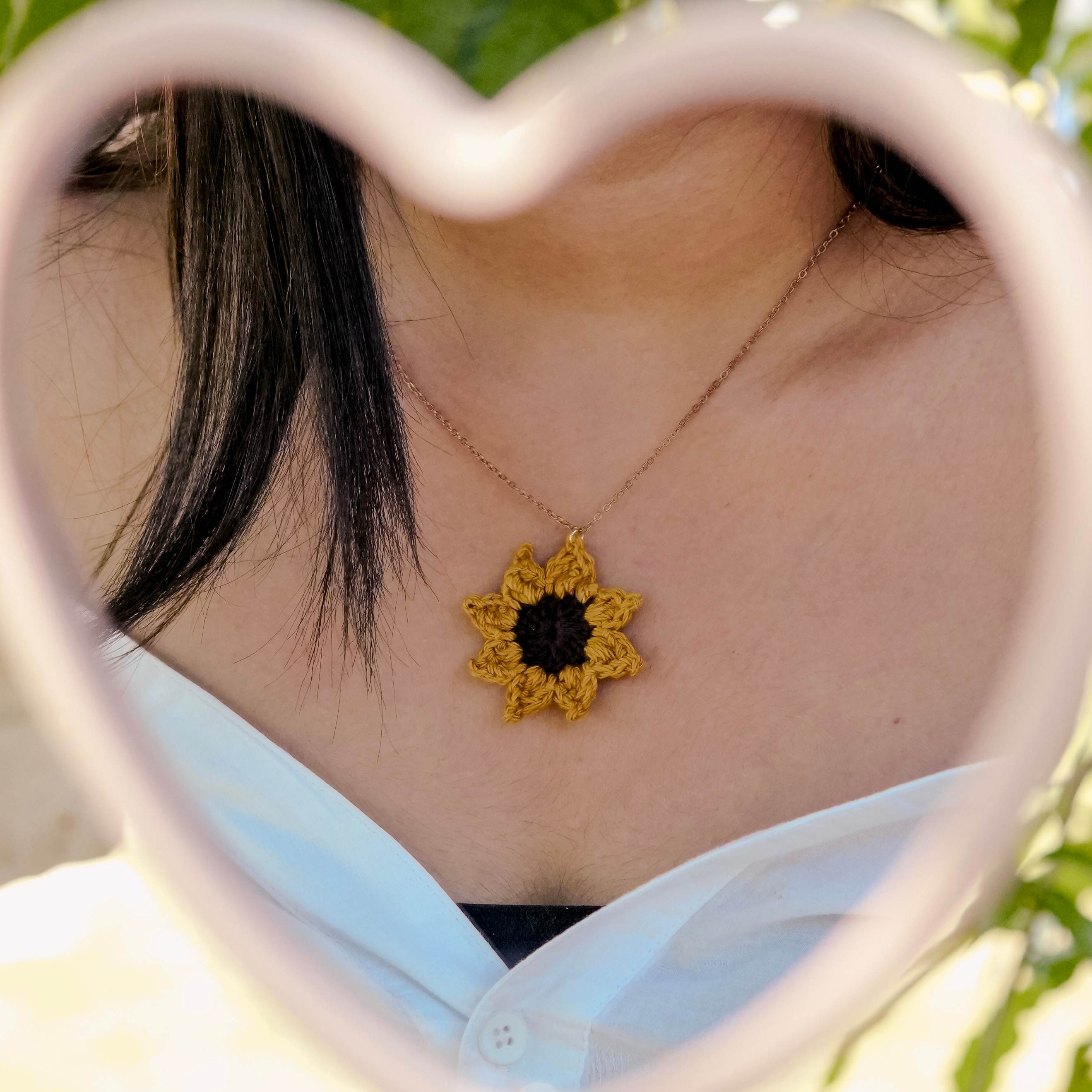 Model wearing the Sunflower Pendant by AHG. Perfect summer accessory!