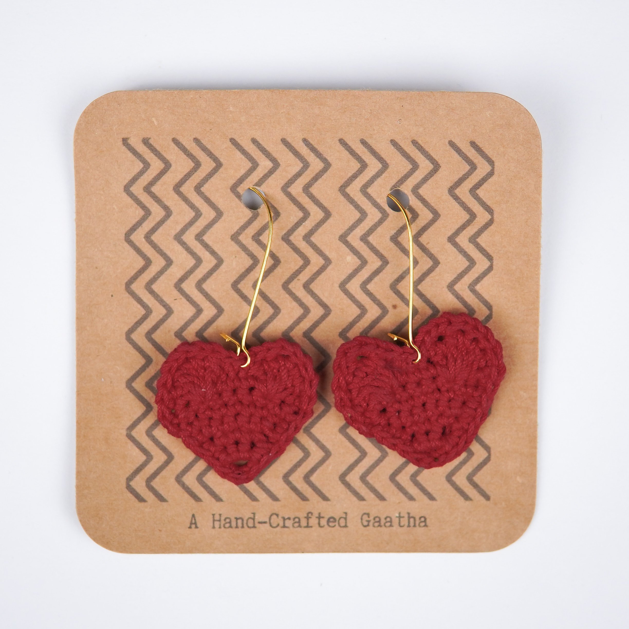  Close-up view of the deep, rich maroon shade of the crochet heart earrings