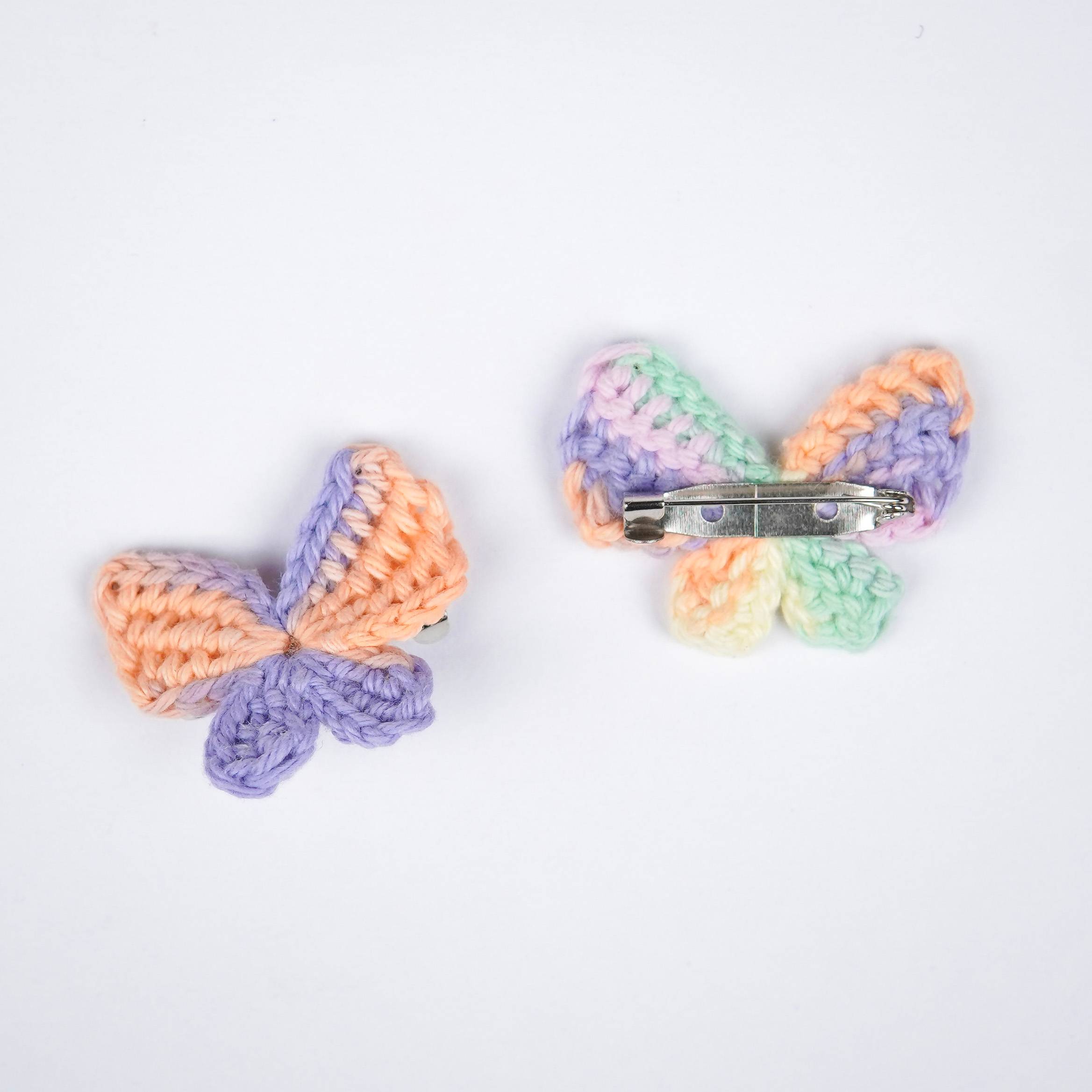  Close-up of AHG's Peach Titli Brooch. Delicate crochet details in a charming shade. 