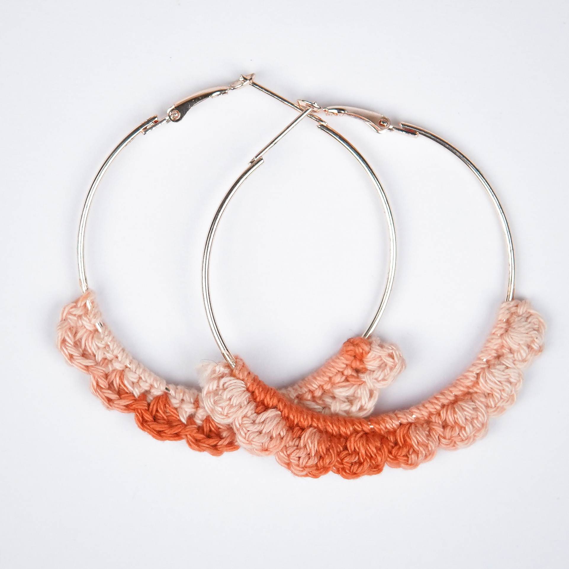Close-up of AHG's Dual-Shade Peach Crochet Nazakat Hoops. Delicate crochet in a beautiful peach blend!
