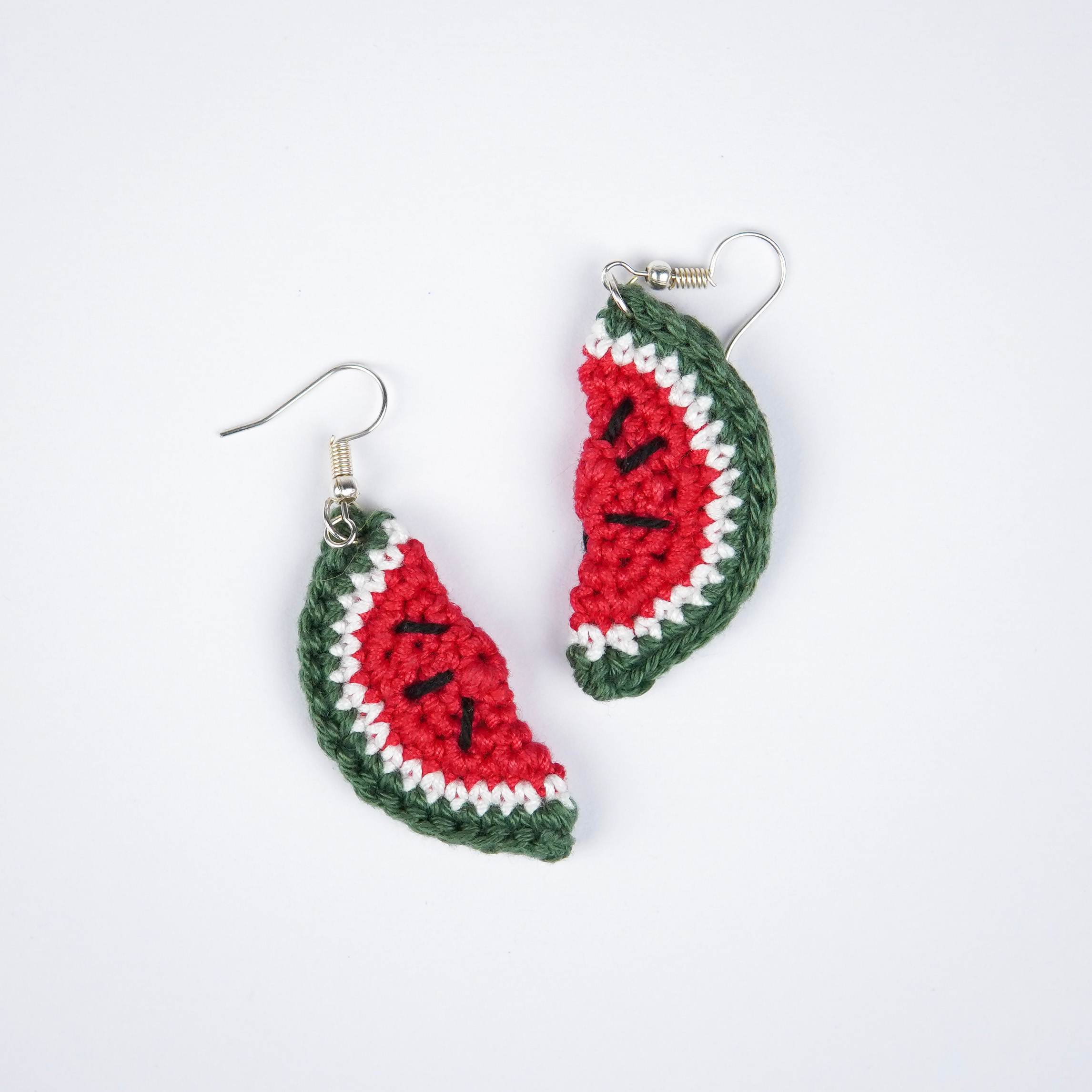 Close-up of AHG's Watermelon Earrings. Delicate details for a refreshing summer look.