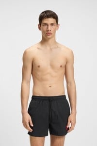 Fully lined swim shorts with red logo label